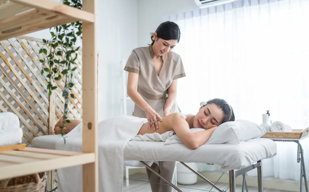 Therapist giving a client a back massage